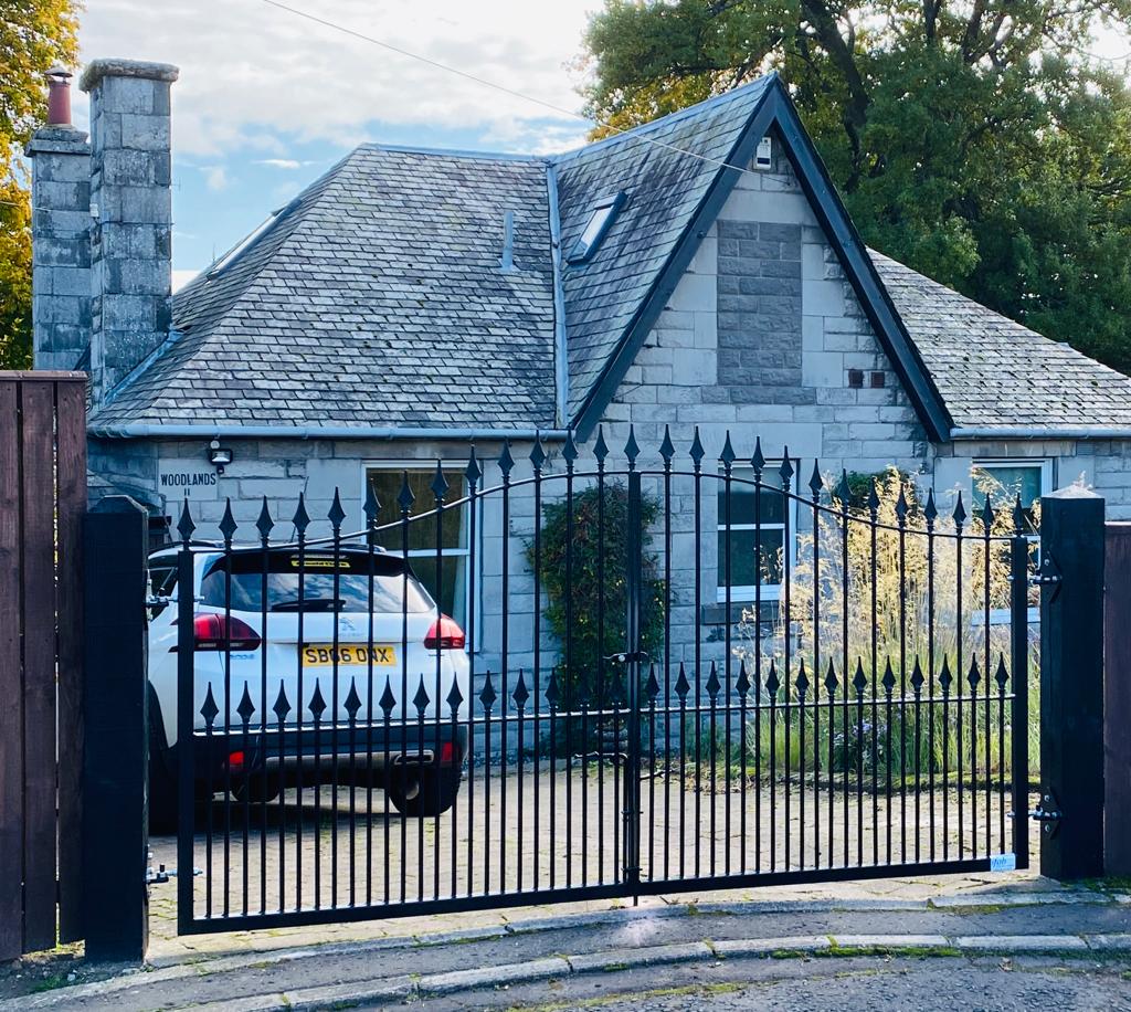 Black double gate outside cottage
