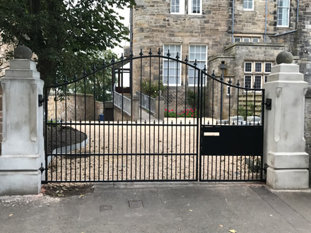 Black automated gate with side gate