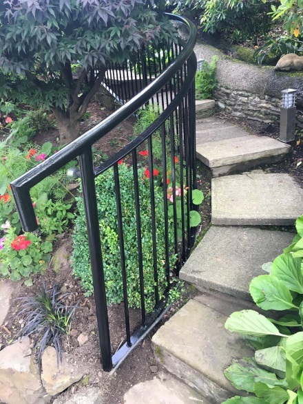 close up of black railing in garden