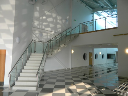 inside large house with glass balustrade on stairs